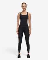 Model trägt greenyogashop Shaped Block High Waist Leggings in Schwarz mit kontrastfarbenen Seiteneinsätzen