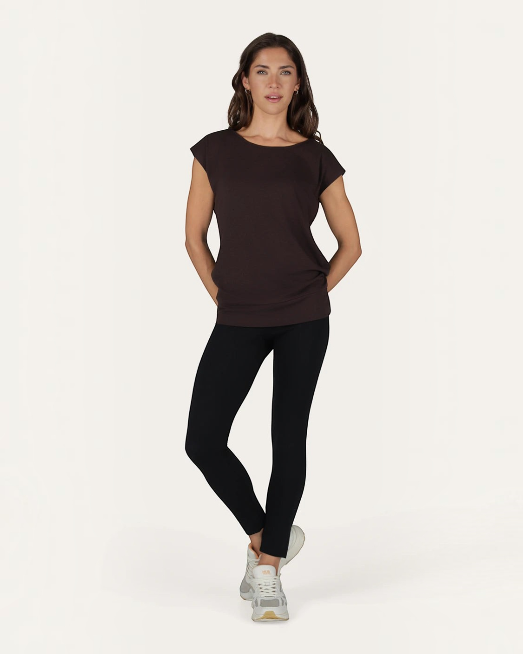 Model trägt das braune greenyogashop Asana Tee aus Bambus-Mix mit lockerer Passform und extra langem Schnitt.